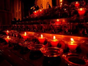 Close-up of lit tea light candles in temple