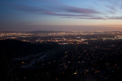 High angle view of illuminated buildings against sky at sunset