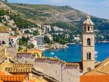 High angle view of buildings by sea