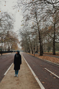 Full length of man walking on road