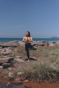 Man on beach against clear sky