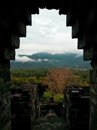 Scenic view of mountains against cloudy sky