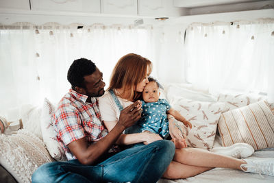 Cheerful family siting in camper van