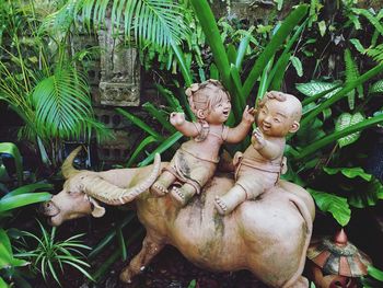 Statue amidst plants in yard