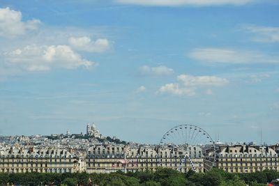 View of cityscape against cloudy sky