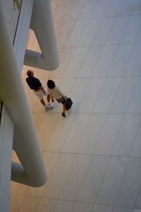 Low section of woman walking on tiled floor