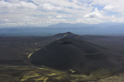 Aerial view of landscape against cloudy sky