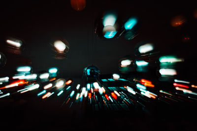 Light trails on illuminated street at night