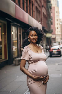 Portrait of young woman standing in city