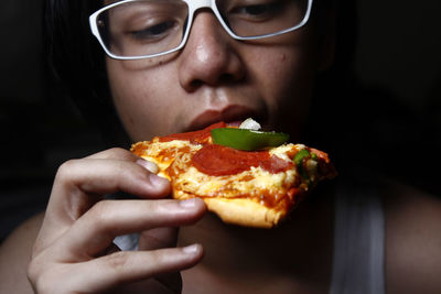 Close-up of boy holding pizza