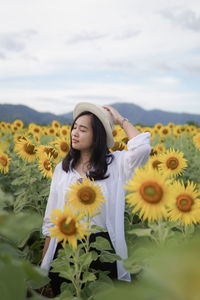 Portrait of young woman holding flowers