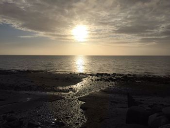 Scenic view of beach against sky during sunset