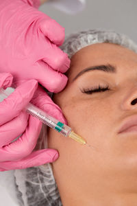 Close-up of doctor injecting syringe