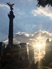 Low angle view of statue against cloudy sky