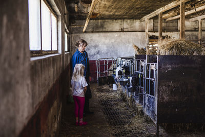 Full length of woman standing in abandoned building