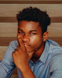 Portrait of young man sitting on staircase