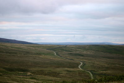 Empty, winding road over dales