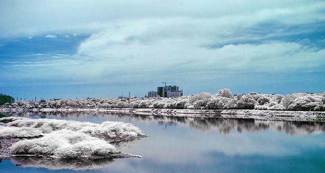 winter, snow, cold temperature, architecture, built structure, sky, building exterior, water, cloud - sky, weather, season, reflection, lake, tranquility, tranquil scene, nature, frozen, cloud, scenics, cloudy