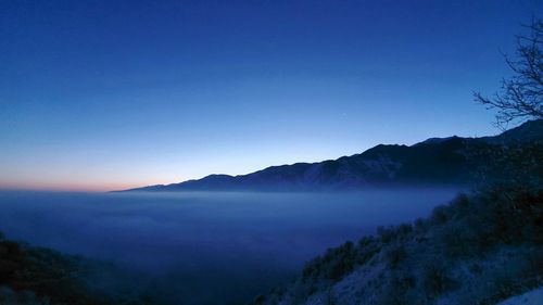 Scenic view of mountains against clear blue sky