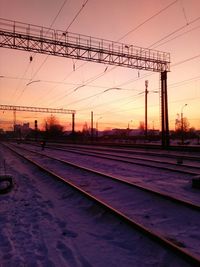 Silhouette electricity pylon against sky during sunset