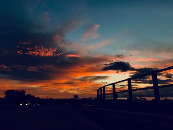 Silhouette bridge against sky during sunset