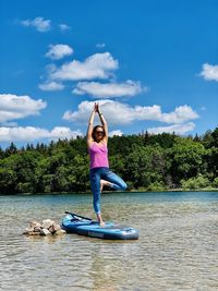 Full length of person in lake against sky