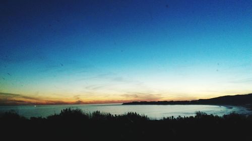 Scenic view of calm lake at sunset