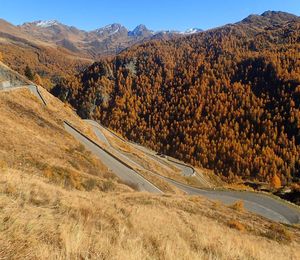 Scenic view of road by mountains against sky