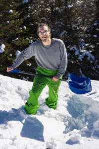 Portrait of smiling man in snow