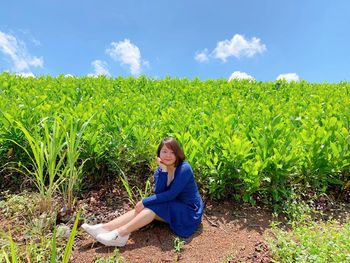 Young woman sitting on field