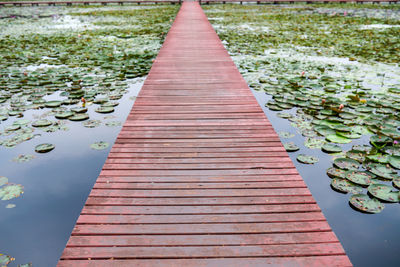 Surface level of wooden footbridge over lake