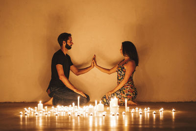 Young couple in illuminated room