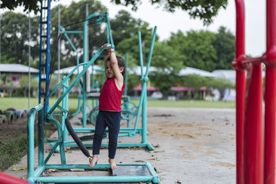 Boy playing on slide at playground