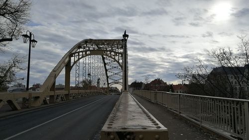 View of suspension bridge against cloudy sky