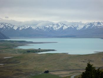 Scenic view of lake and mountains against sky