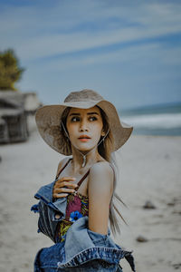 Portrait of beautiful young woman wearing hat