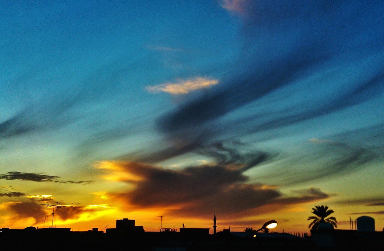 sunset, silhouette, sky, cloud - sky, orange color, beauty in nature, building exterior, dramatic sky, scenics, built structure, low angle view, architecture, cloud, nature, moody sky, tranquility, tranquil scene, cloudy, idyllic, dusk