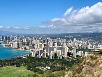 High angle view of buildings by sea against sky