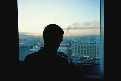 Woman looking through window