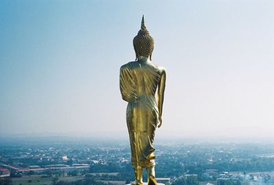 Statue against buildings in city