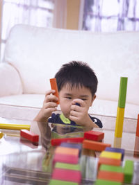 Boy playing with colorful toys at home