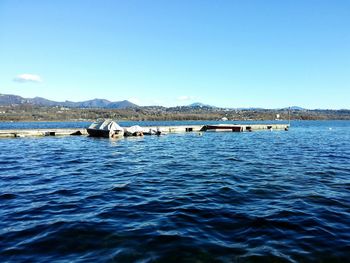 Calm sea with mountain range in background