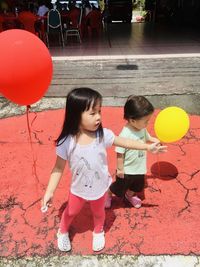 Cute girl holding balloons