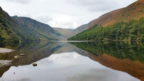 Scenic view of lake surrounded by mountain