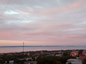 High angle view of townscape by sea against sky