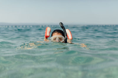 Portrait of woman swimming in sea