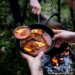 Cropped image of person preparing food on barbecue grill