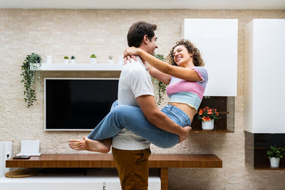 Young woman sitting on sofa at home