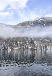 Scenic view of lake against sky during winter