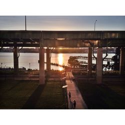 People walking in city at sunset